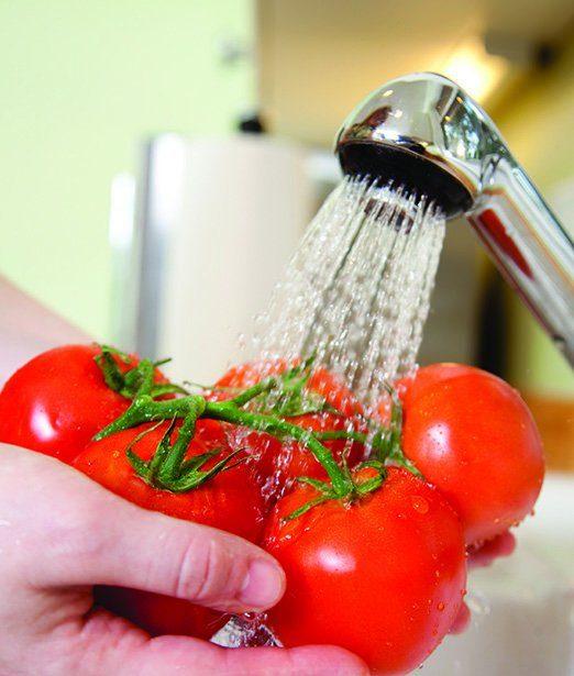 Tomatoes being washed with gentle water spray