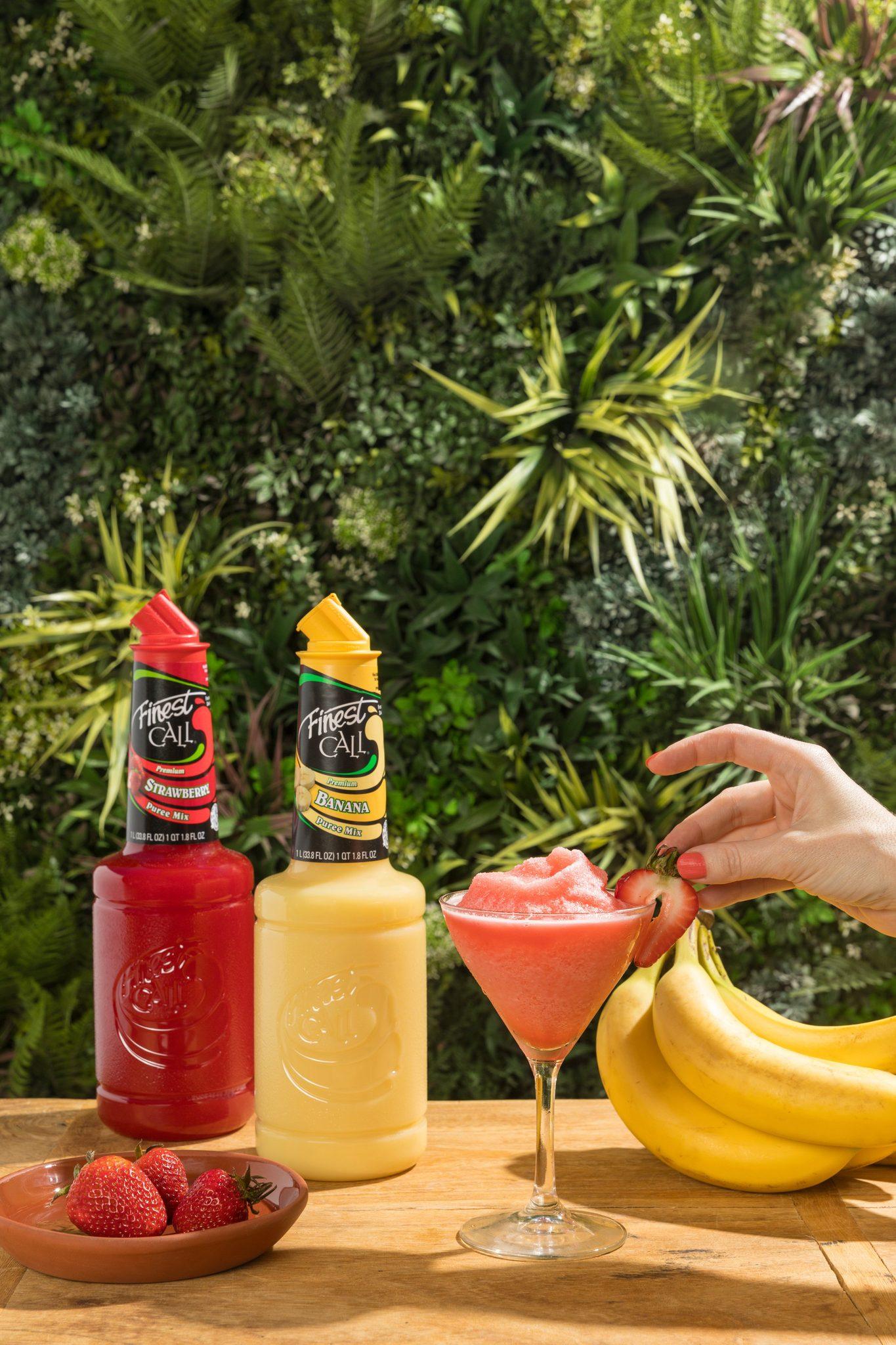 Cocktails against a lush tropical foliage backdrop