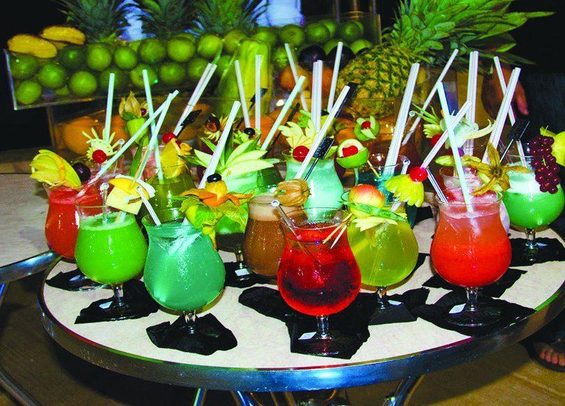 Colorful tropical cocktails garnished with pineapple tops